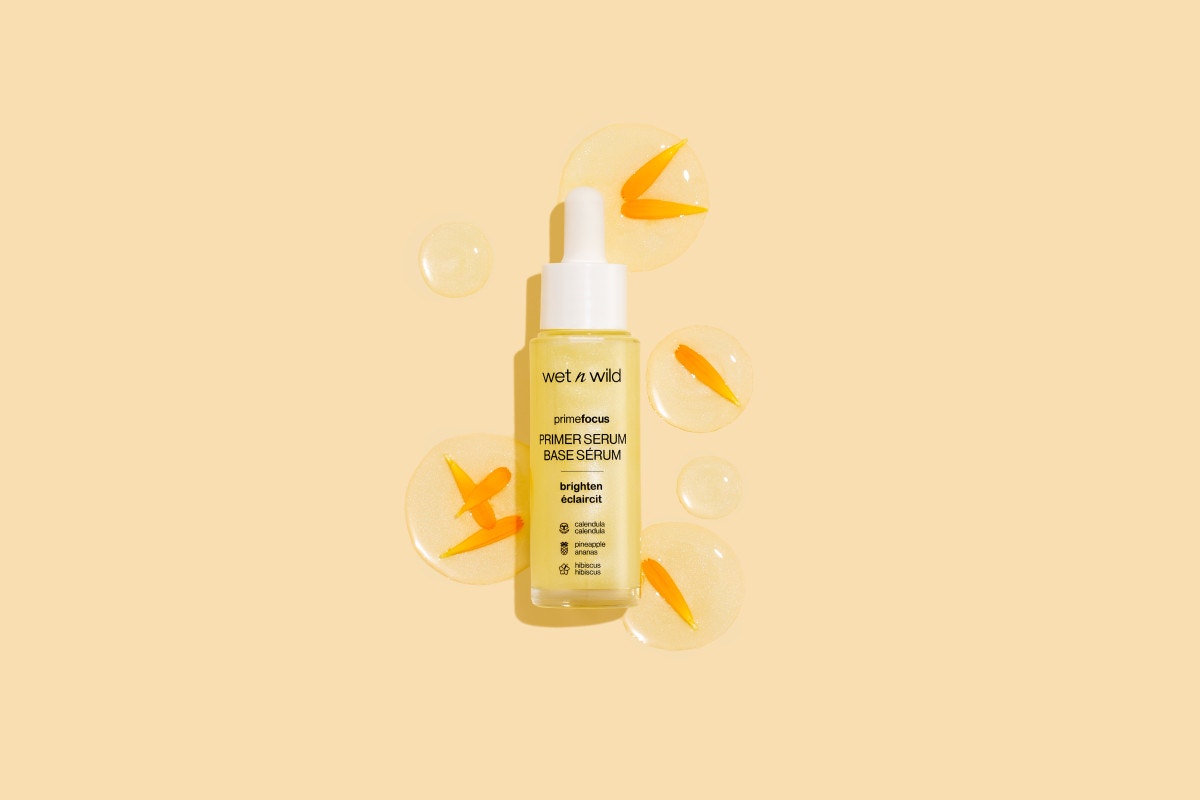 Wet n wild | Prime Focus Brightening Primer Serum | Products displayed besides a floral arrangement