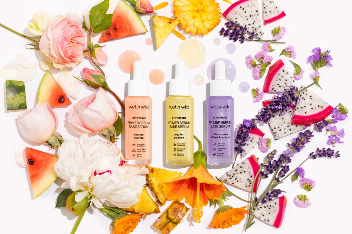 Wet n wild | Prime Focus Brightening Primer Serum | Product front facing lid closed, with floral background